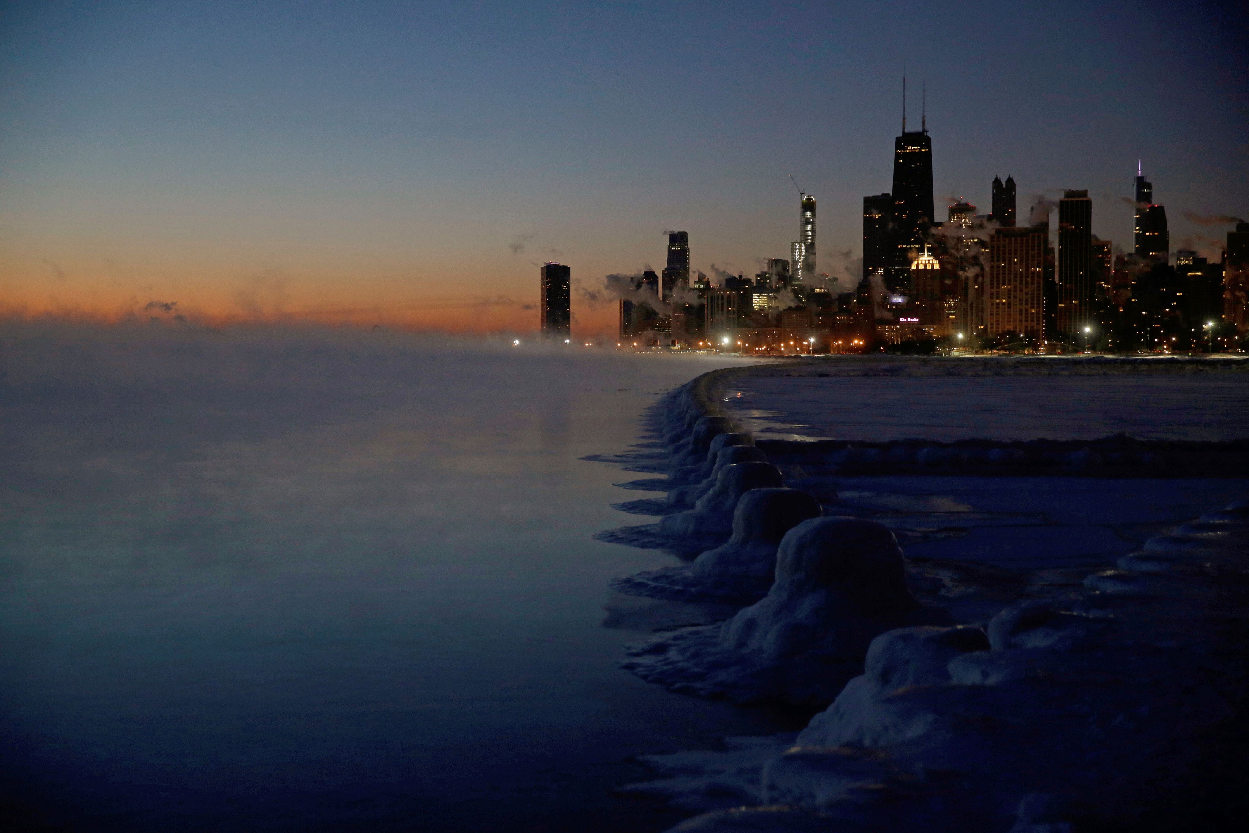 Ice forms along the shore of Lake Michigan before sunrise, Thursday, Jan. 31, 2019, in Chicago. The painfully cold weather system that put much of the Midwest into a historic deep freeze was expected to ease Thursday, though temperatures still tumbled to record lows in some places. (AP Photo/Kiichiro Sato)