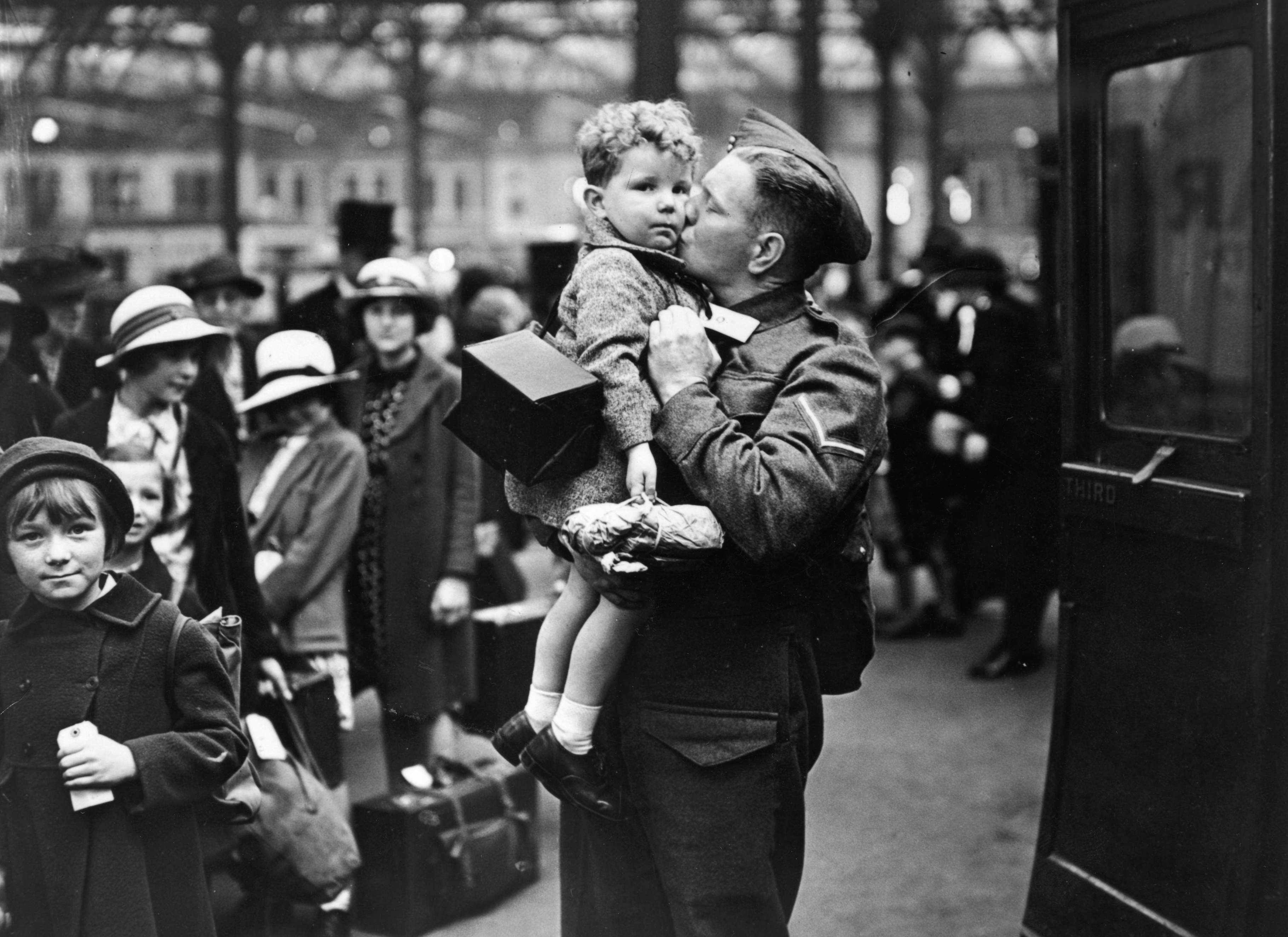 Slide 1 of 50: 13th June 1940: A soldier home on leave from the British Expeditionary Force, says goodbye to his baby son at the evacuation point in Greater London. (Photo by Topical Press Agency/Getty Images)