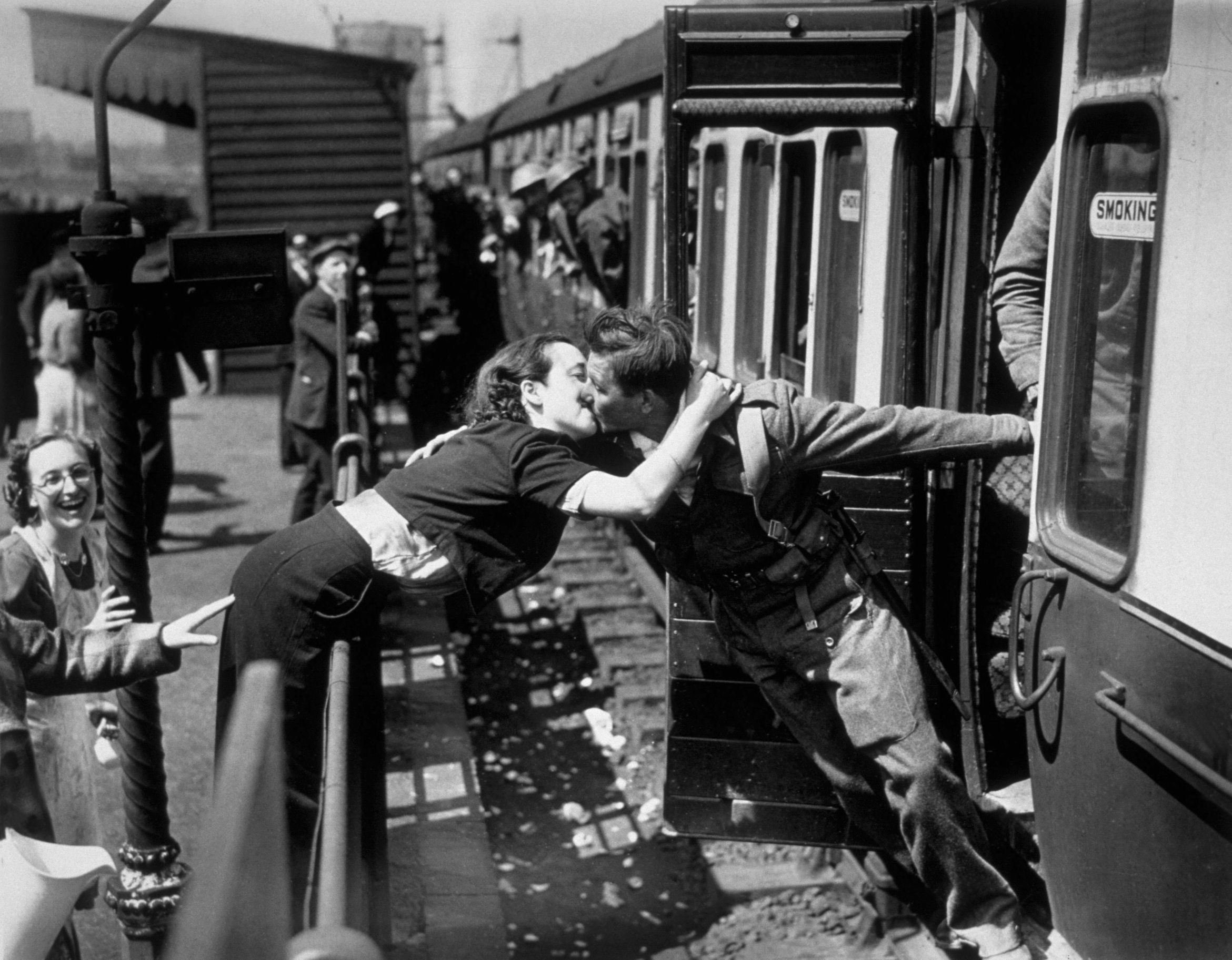 Slide 7 of 50: A soldier of the British Expeditionary Force, arriving back from Dunkirk, is greeted affectionately by his girlfriend. (Photo by Topical Press/Getty Images)