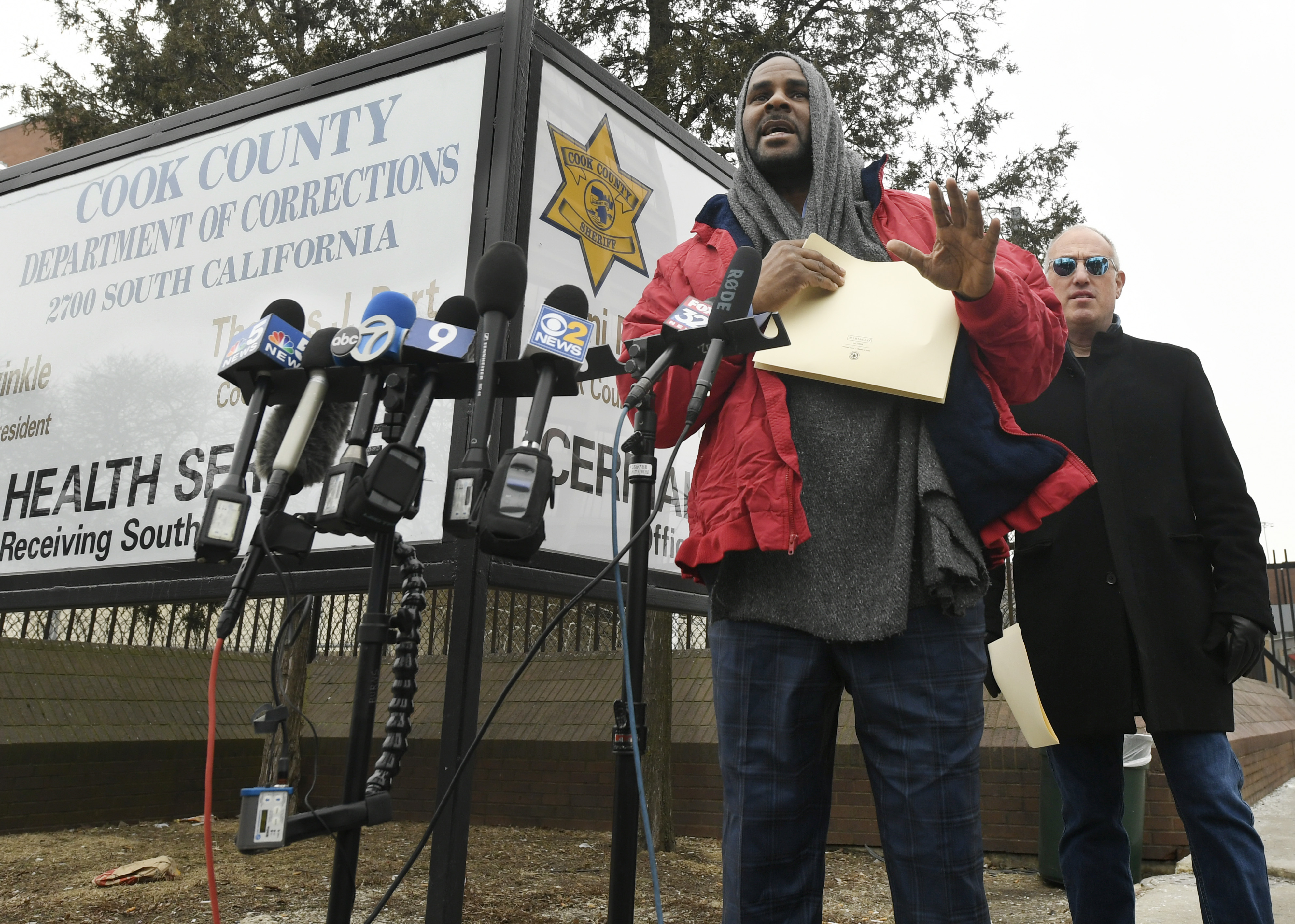 Singer R. Kelly left, speaks to the media while his attorney Steve Greenberg right, looks on after being released from Cook County Jail, March 9, 2019, in Chicago. Kelly was freed three days after a judge ordered him jailed until he paid the total amount of back child support that he owed. (AP Photo/Paul Beaty)