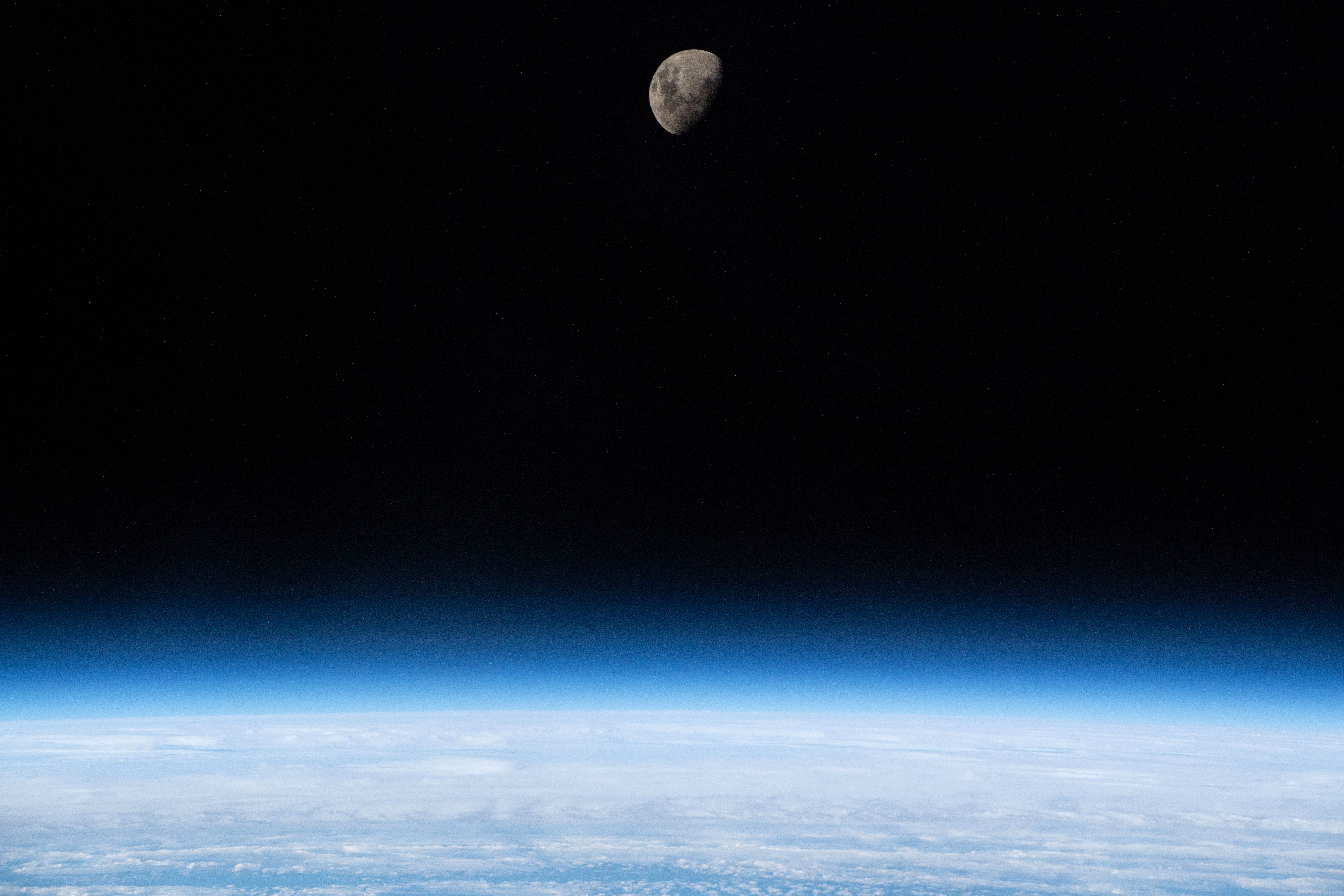 Slide 1 of 111: A waxing gibbous Moon is seen above Earth's limb as the International Space Station was orbiting 266 miles above the South Atlantic Ocean.
