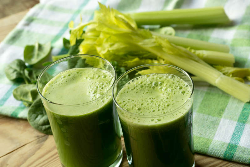 fresh green spinach leaves and  celery juice in glass
