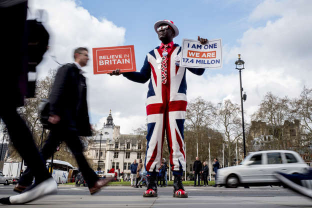 Slide 1 of 43: A pro-Brexit campaigner wears the Union flag colours and holds placards as he demonstrates near the Houses of Parliament in central London on April 3, 2019. - Prime Minister Theresa May was to meet on Wednesday with the leader of Britain's main opposition party in a bid to thrash out a Brexit compromise with just days to go until the deadline for leaving the bloc. (Photo by Tolga Akmen / various sources / AFP)        (Photo credit should read TOLGA AKMEN/AFP/Getty Images)