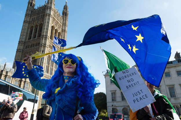 Slide 2 of 43: Pro EU demonstrators hold placards and EU flags as they protest outside the Houses of Parliament on 10 April, 2019 in London, England.