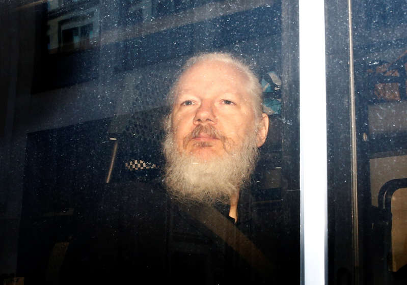 WikiLeaks founder Julian Assange in the back of a police van after his arrest.
