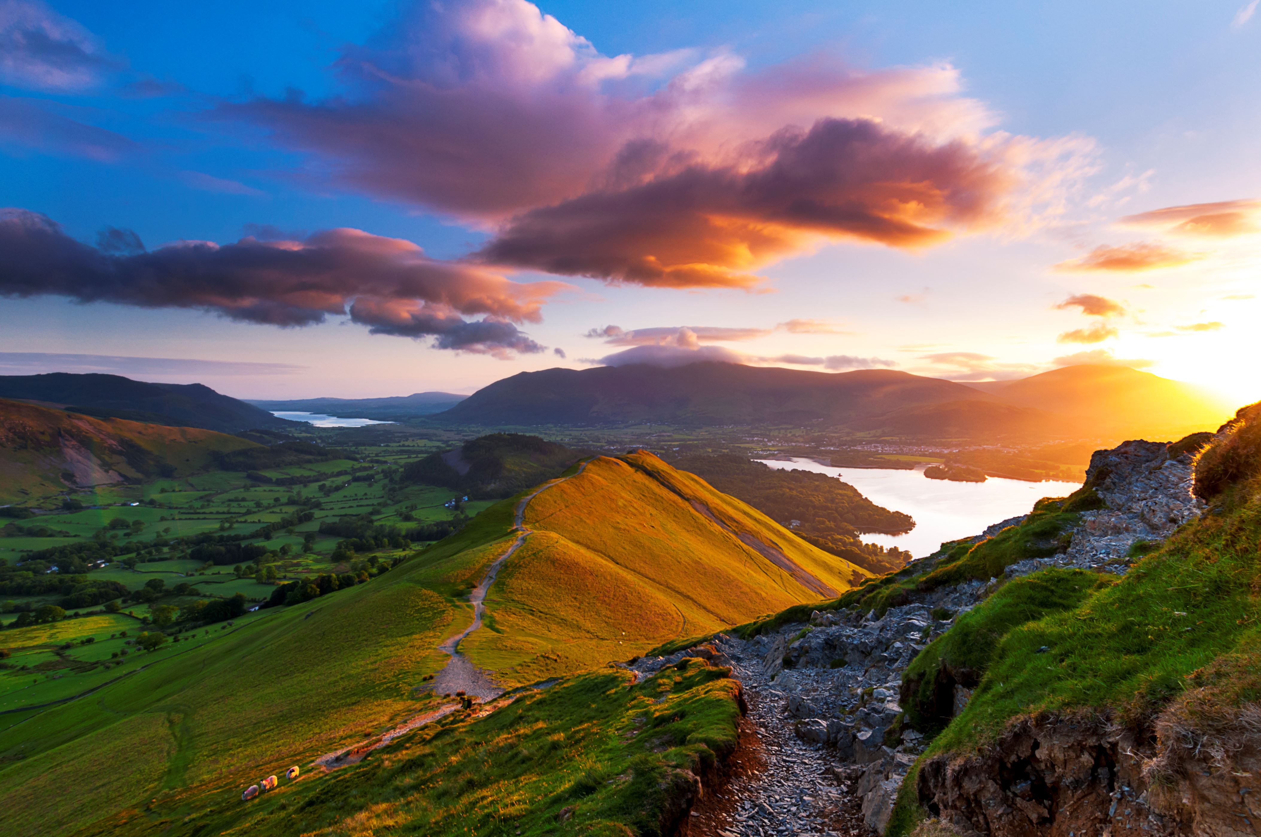 ����� 32 �� 34: Sunrise from Catbells fell in the Cumbrian mountains; golden light at sunrise and a moody vivid sky, makes for a atmospheric feel to this Lake District landscape image, taken on Catbells Fell near Keswick, looking North towards Skiddaw massive. Keswick, Lake District, Cumbria. UK, Europe.