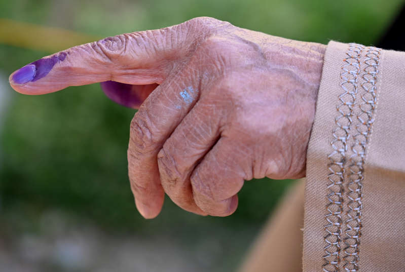 A Kashmiri woman shows her finger marked with indelible ink after casting her vote at a polling station during the third phase of India's general election, at Khanabal of Anantnag district, south of Srinagar on April 23, 2019.