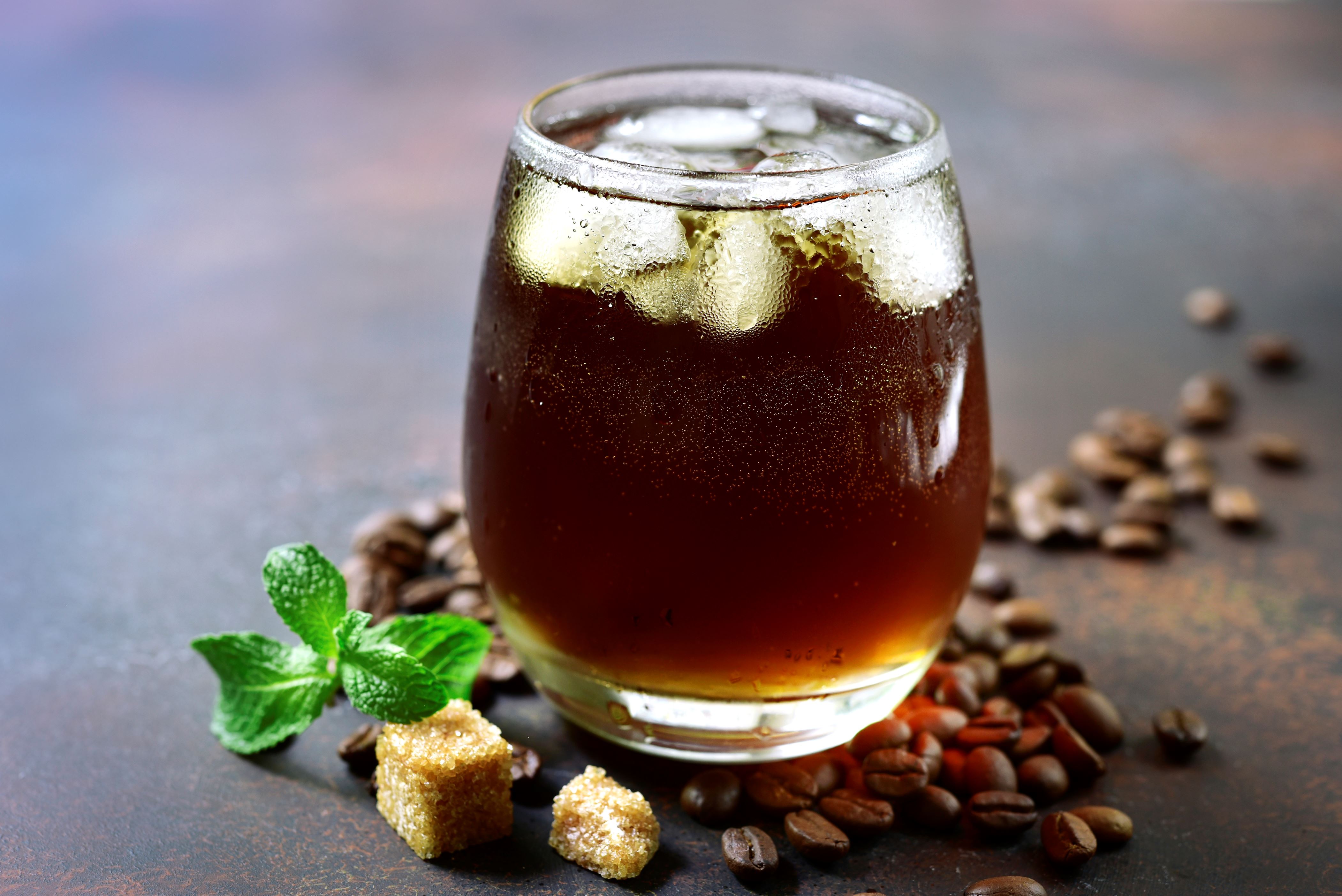 Cold summer cocktail with cola,whiskey and coffee liquor in a glass on a dark slate, stone or concrete background