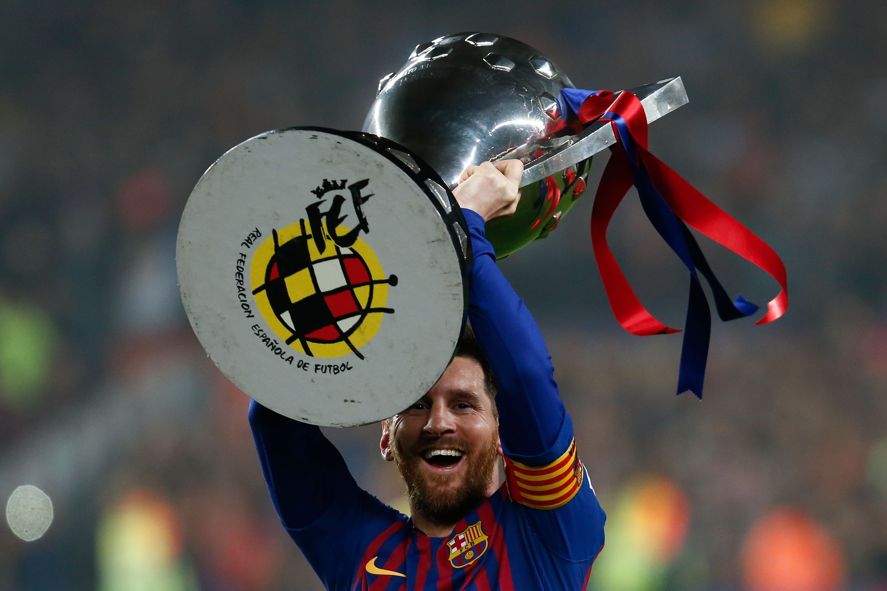 Slide 1 of 24: Barcelona's Argentinian forward Lionel Messi celebrates with the Liga trophy as Barcelona won their 26th league title after the Spanish League football match between Barcelona and Levante at the Camp Nou stadium in Barcelona on April 27, 2019. (Photo by PAU BARRENA / AFP) (Photo credit should read PAU BARRENA/AFP/Getty Images)