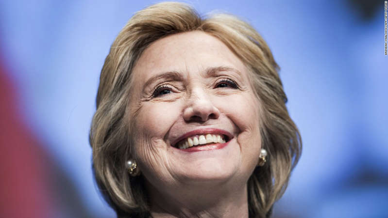 a close up of Hillary Clinton: Former Secretary of State Hillary Clinton smiles before speaking at the World Bank May 14, 2014 in Washington, DC. Clinton and World Bank President Jim Yong Kim joined others to speak about women's rights.