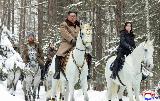 Slide 2 of 65: This undated photo provided on Wednesday, Dec. 4, 2019, by the North Korean government shows North Korean leader Kim Jong Un, center, with his wife Ri Sol Ju, right, riding on white horse during his visit to Mount Paektu, North Korea. North Korea says leader Kim has taken a second ride on a white horse to a sacred mountain in less than two months. Independent journalists were not given access to cover the event depicted in this image distributed by the North Korean government. The content of this image is as provided and cannot be independently verified. Korean language watermark on image as provided by source reads: 