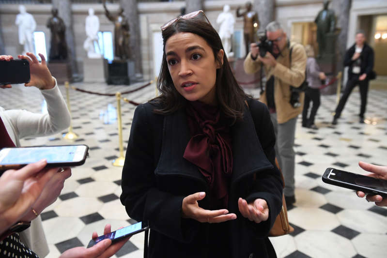 Rep. Alexandria Ocasio-Cortez talks with reporters at the Capitol on December 18, 2019.