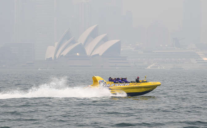 Slide 4 of 49: SYDNEY, AUSTRALIA - DECEMBER 19: A tourist boat rides on the Harbour in thick smoke on December 19, 2019 in Sydney, Australia. NSW Premier Gladys Berejiklian has declared a state of emergency for the next seven days with ongoing dangerous fire conditions and almost 100 bushfires burning across the state. It's the second state of emergency declared in NSW since the start of the bushfire season.