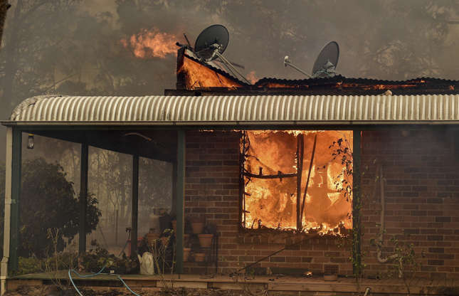Slide 3 of 49: A property burns from bushfires in Balmoral, 150 kilometres southwest of Sydney on December 19, 2019. - A state of emergency was declared in Australia's most populated region on December 19, as a record heat wave fanned unprecedented bushfires.