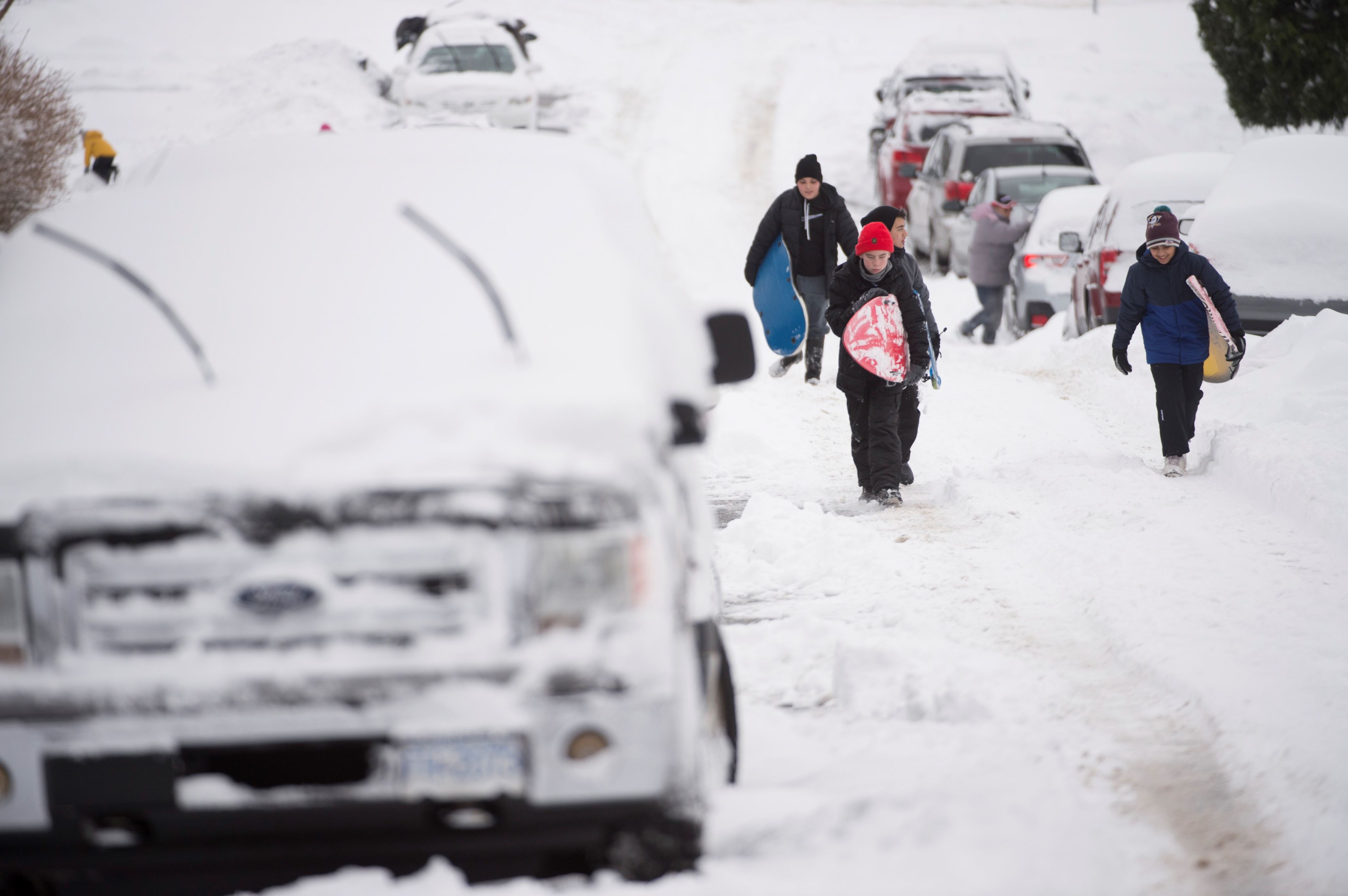 Slide 23 of 23: People use the street to slide down following a major snow storm in Burnaby, B.C., Wednesday, January 15, 2020. Vancouver and the lower mainland have been pounded with heavy snow fall and freezing temperatures.