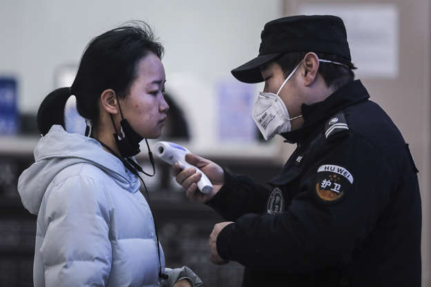 Slide 1 of 14: WUHAN, CHINA - JANUARY 22: (CHINA OUT) Security personnel check the temperature of passengers in the Wharf at the Yangtze River on January 22, 2020 in Wuhan, Hubei province, China. A new infectious coronavirus known as "2019-nCoV" was discovered in Wuhan as the number of cases rose to over 400 in mainland China. Health officials stepped up efforts to contain the spread of the pneumonia-like disease which medicals experts confirmed can be passed from human to human. The death toll has reached 17 people as the Wuhan government issued regulations today that residents must wear masks in public places. Cases have been reported in other countries including the United States, Thailand, Japan, Taiwan, and South Korea. (Photo by Getty Images)