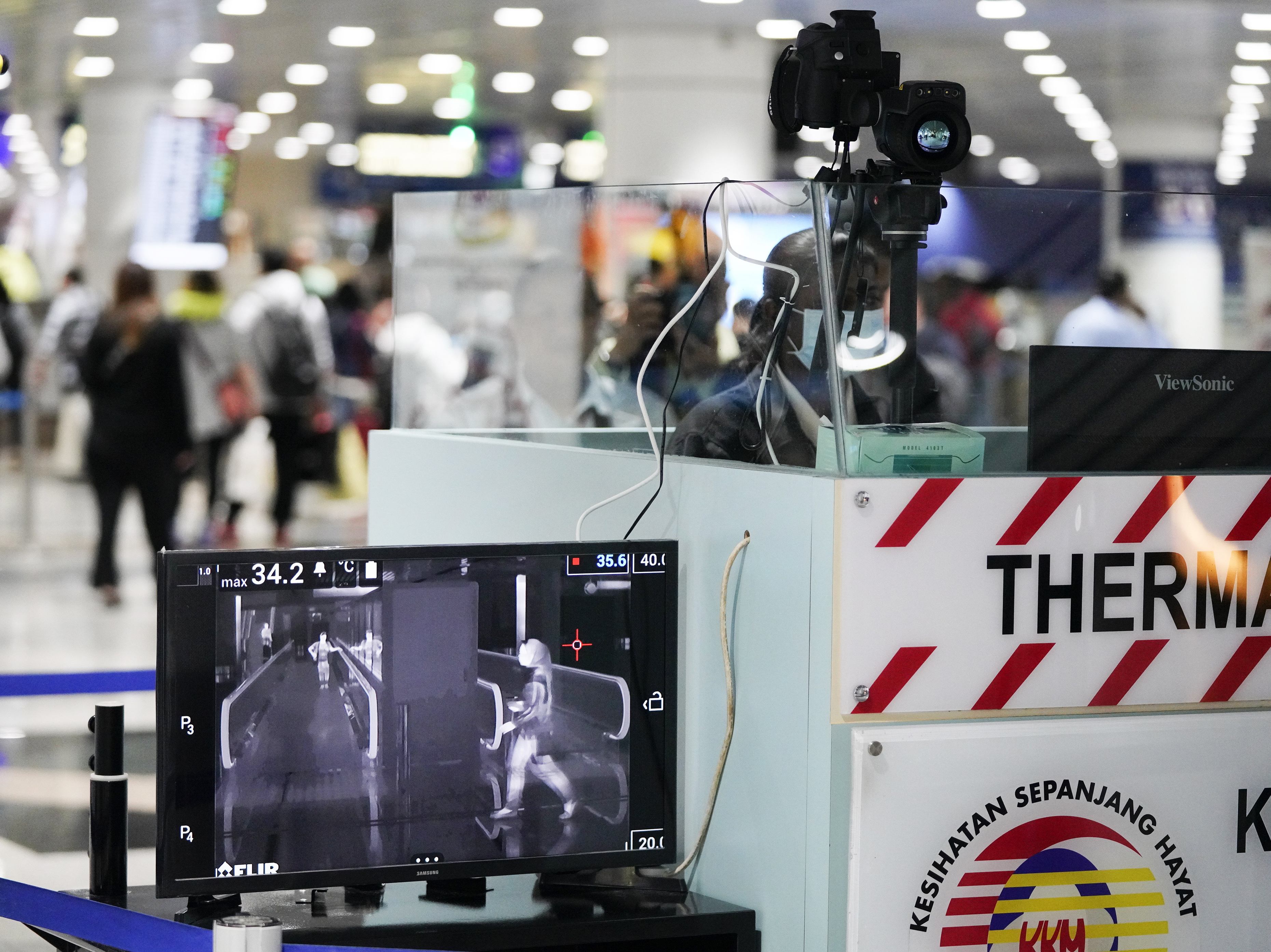 Slide 90 of 94: Health officials watch travelers on a thermographic monitor at the Kuala Lumpur International Airport in Sepang, Malaysia, Tuesday, Jan. 21, 2020.