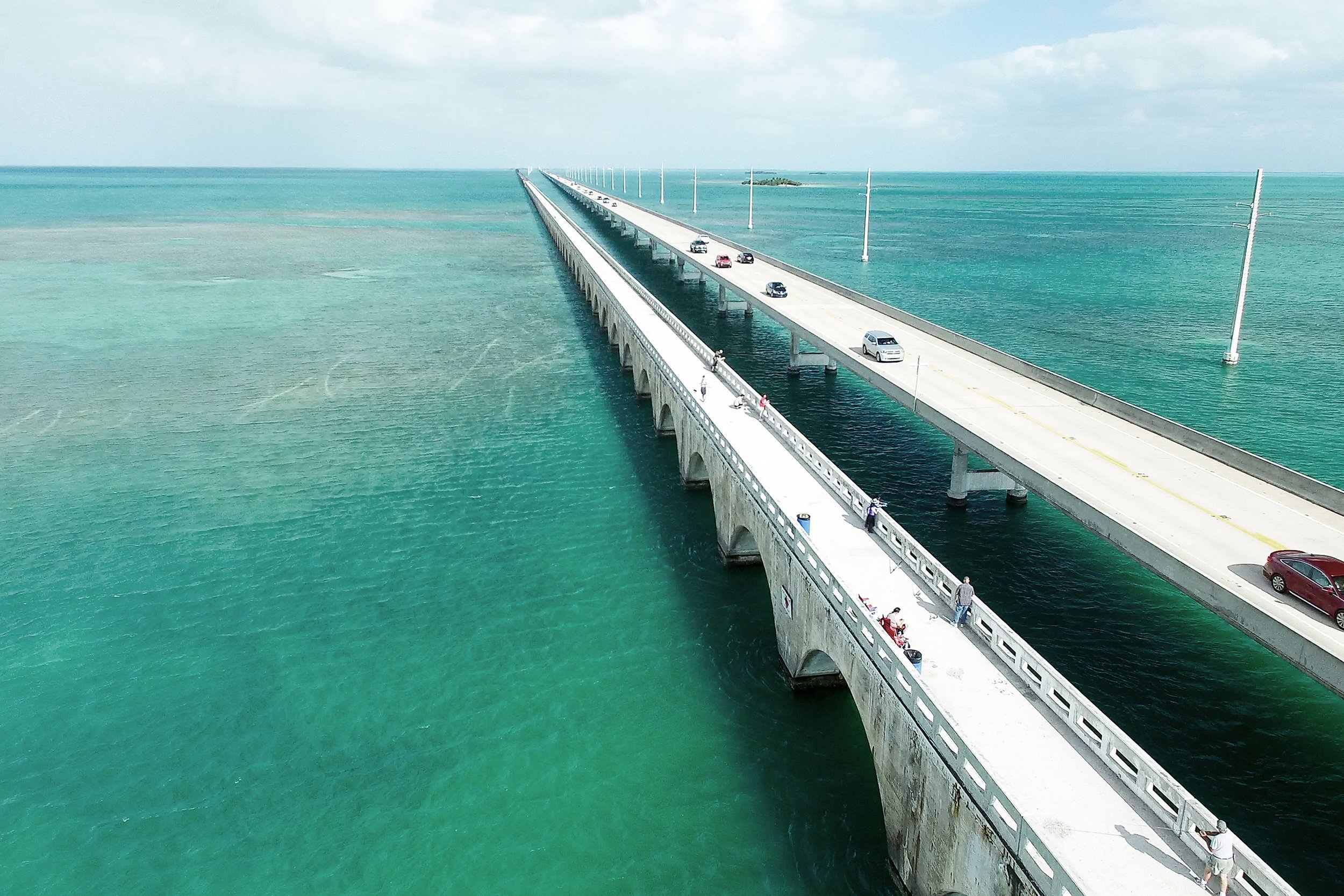 <p>The striking Overseas Highway, also known here as Highway 1 or the "Highway That Goes to the Sea," includes 112 miles of roadway and a total of 42 overseas bridges <a href="https://www.cheapism.com/blog/fun-cheap-things-to-do-in-miami-4057/">from Miami to Key West</a>. The entire span can be traveled in about four hours, but it's better to take time to enjoy the trip. Keep an eye out for restaurants and attractions along the way. Stopping at the National Key Deer Refuge on Big Pine Key — the only home of this endangered species — is free, for instance.</p>