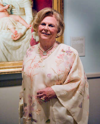 Slide 7 of 20: Jacqueline Mars, executive and part-owner of Mars Inc., stands for a photo in front of a painting by Marie-Genevieve Bouliar at the National Museum of Women in the Arts 25th Anniversary Gala which she co-chaired in Washington, D.C., U.S., on Friday, April 27, 2012.