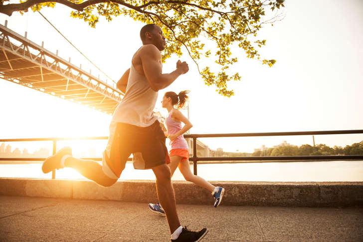 two people running by eachother by river