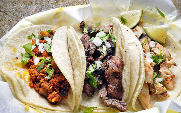 Diapositiva 33 de 51: From left to right, chorizo, carne asada, and pullo asado tacos at Taco Trio in South Portland.