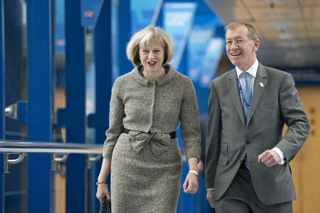 Slide 2 of 20: Home Secretary Theresa May and her husband Philip, arrive to listen to Prime Minster David Cameron's keynote address on the final day of the annual Conservative Party Conference in Birmingham, central England, on October 1, 2014. Talk of treason cast a shadow over Britain's Conservative party conference this week, where gossip raged over who might be next to defect to the anti-EU UK Independence Party (UKIP).  AFP PHOTO / OLI SCARFF        (Photo credit should read OLI SCARFF/AFP/Getty Images)