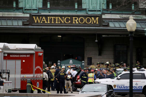 Emergency officials stand outside of the Hoboken Terminal following a train crash, Thursday, Sept. 29, 2016, in Hoboken, N.J. A commuter train crashed into the rail station during the morning rush hour, causing serious damage. (AP Photo/Julio Cortez)