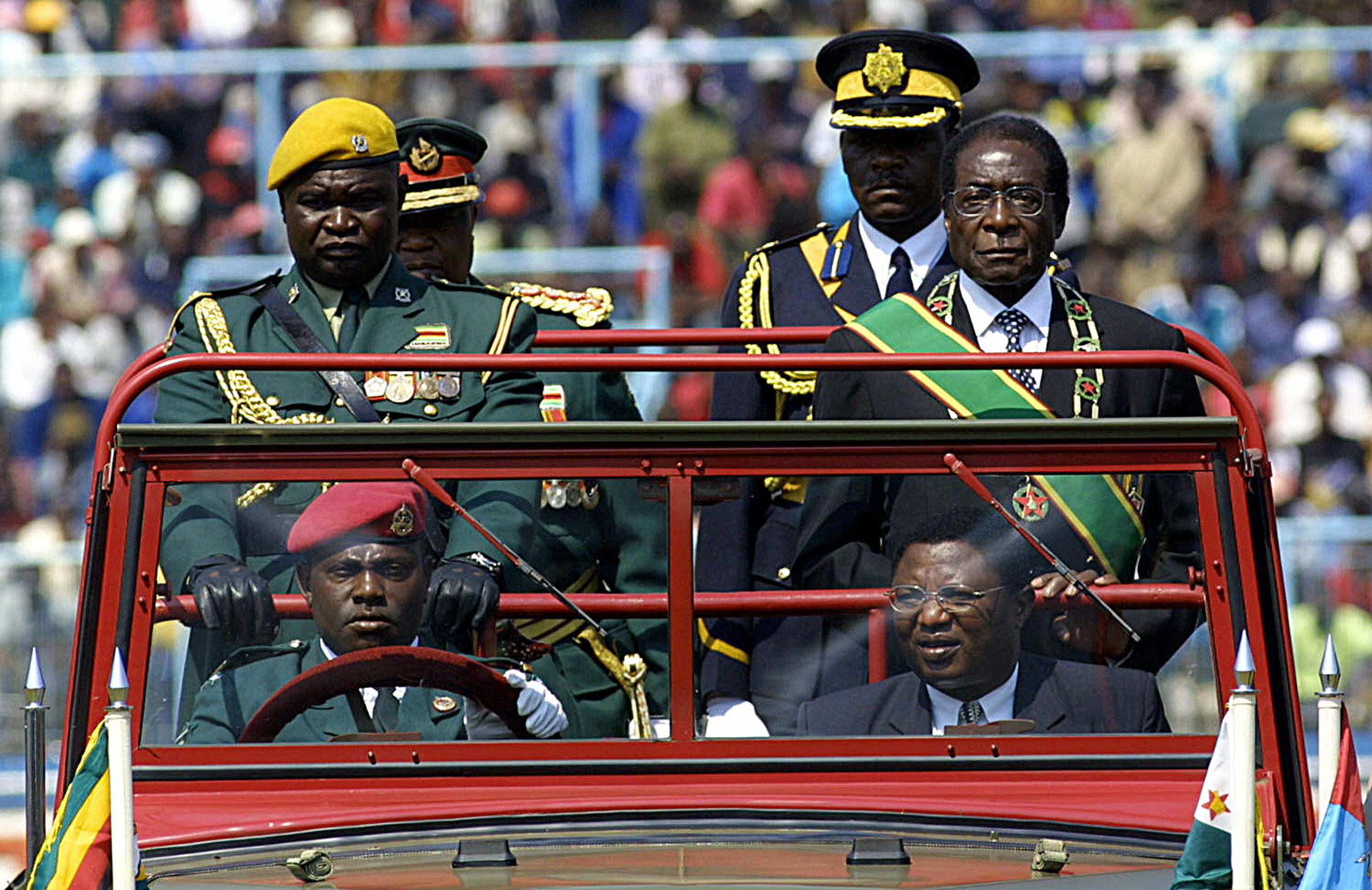 Slide 20 of 26: Harare, ZIMBABWE:  Zimbabwean President Robert Mugabe (2nd row-R) parade with some of the 20 Zimbabwean officers and military staff who fought in the Democratic Republic of Congo from 1998 to 2002, 09 August 2005. 'The timely intervention in the Congo by