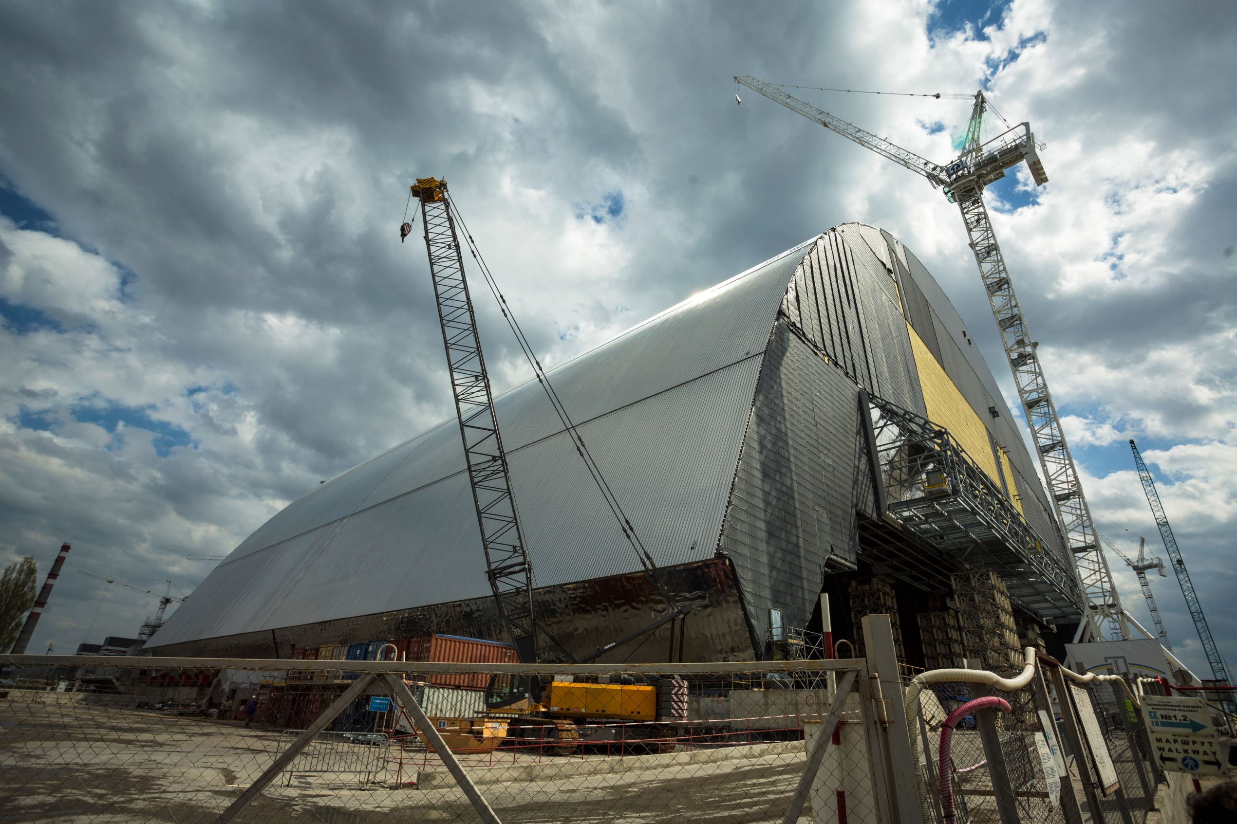 Slide 7 of 14: Construction site structures New Safe Confinement (NSC) in front of the housing and maintenance area, built over the destroyed fourth block of the Chernobyl Nuclear Power Plant near Pripyat April 22, 2016.
April 26, 2016 will mark the 30th anniversary of