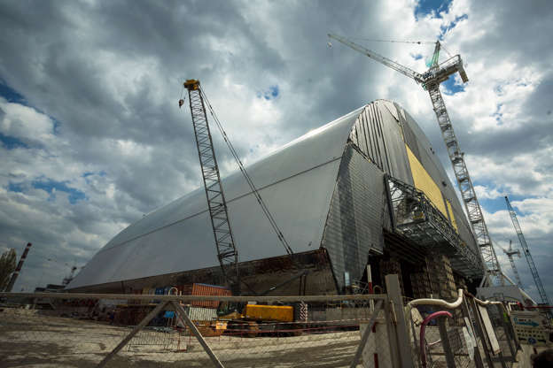 Slide 7 of 14: Construction site structures New Safe Confinement (NSC) in front of the housing and maintenance area, built over the destroyed fourth block of the Chernobyl Nuclear Power Plant near Pripyat April 22, 2016.
April 26, 2016 will mark the 30th anniversary of