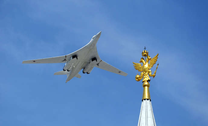 Slide 2 of 14: A Russian Tupolev Tu-160 Blackjack strategic bomber flies over Red Square during the Victory Day military parade in Moscow on May 9, 2015. Russian President Vladimir Putin presides over a huge Victory Day parade celebrating the 70th anniversary of the So
