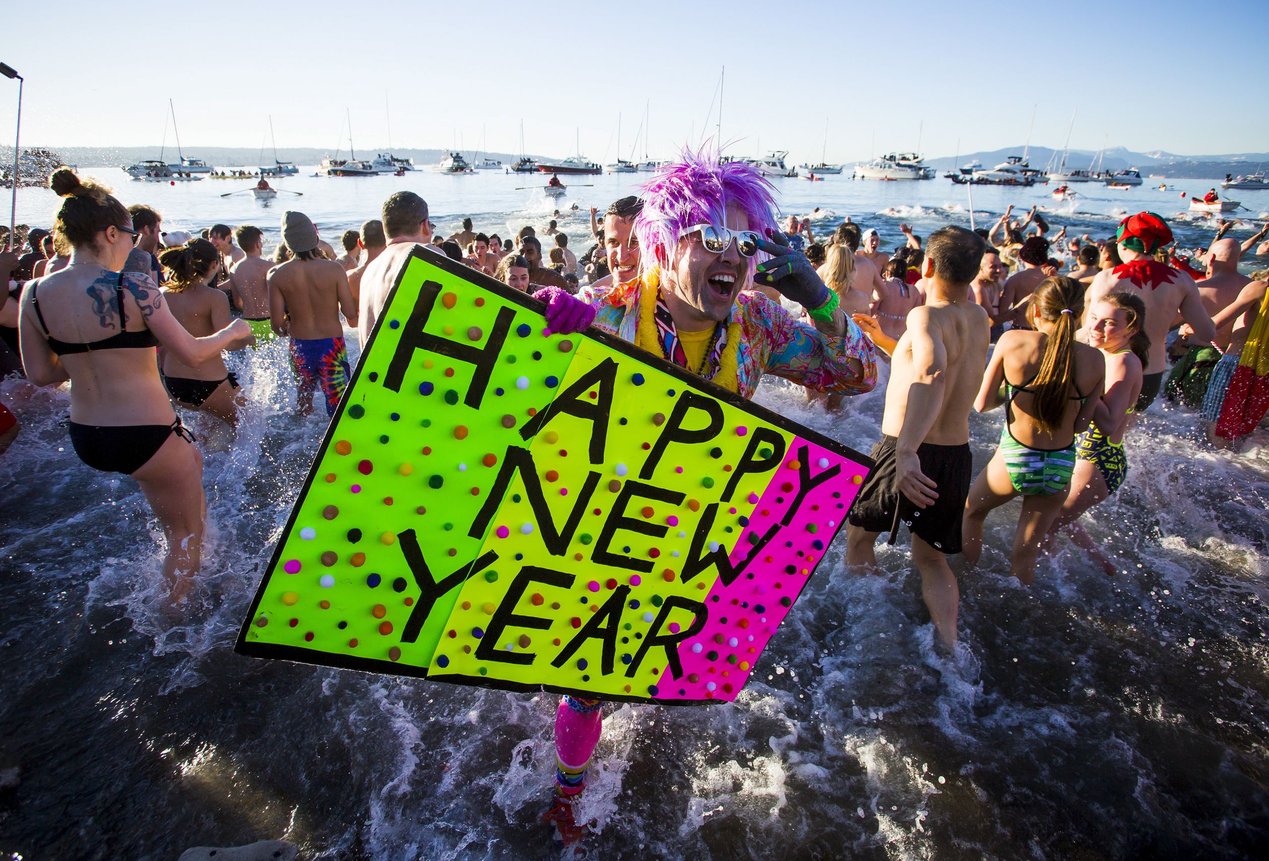 Participants run into English Bay during the 96th annual New Year's Day Polar Bear Swim in Vancouver, British Columbia January 1, 2016. REUTERS/Ben Nelms TPX IMAGES OF THE DAY