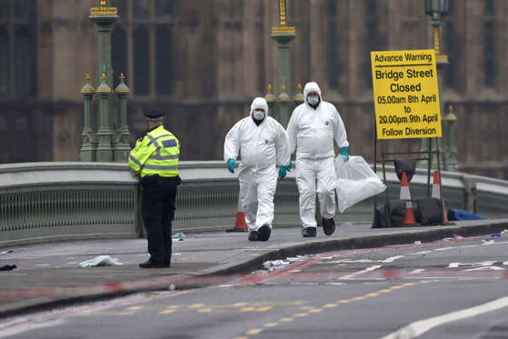Slide 1 of 48: Police forensic officers work on Westminster Bridge following yesterday's attack, on March 23, 2017 in London, England. Four people have been killed and around 40 people injured following yesterday's attack by the Houses of Parliament in Westminster.