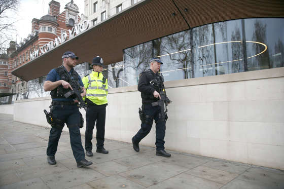 Slide 3 of 48: Armed police officers patrol outside New Scotland Yard the morning after an attack by a man driving a car and weilding a knife left five people dead and dozens injured, in London, Britain, March 23, 2017.