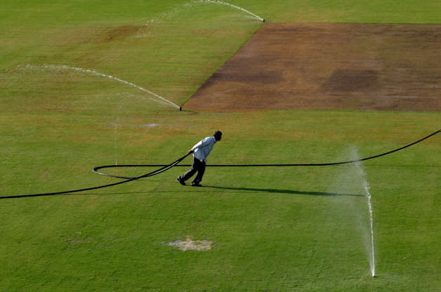 Slide 20 of 20: India Pakistan Cricket - Mar 2005 Workers Drag Watering Hoses Across the Cricket Ground to Water the Pitch at the Ferozshah Kotla Stadium in New Delhi India On Tuesday 22 March 2005 Ahead of the Sixth One-day International Match Between India and Pakista