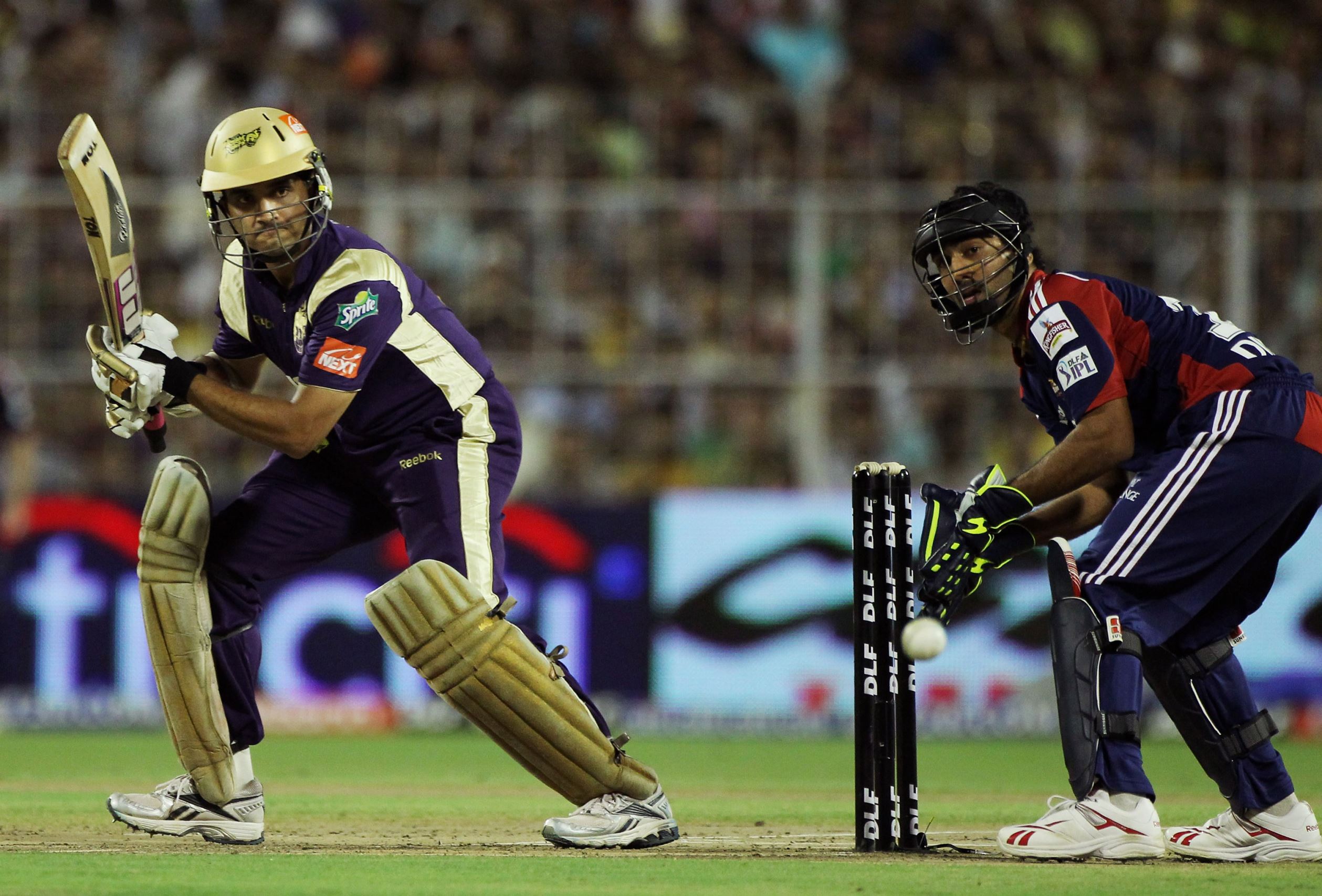 Slide 6 of 20: KOLKATA, INDIA - APRIL 07: Sourav Ganguly of the Knight Riders cuts as Dinesh Karthik of the Daredevils looks on during the 2010 DLF Indian Premier League T20 group stage match between Kolkata Knight Riders and Delhi Daredevils played at Eden Gardens on