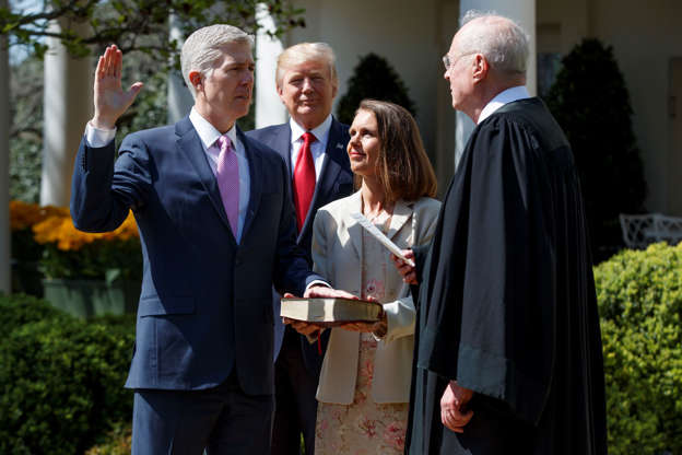 President Donald Trump watches as Supreme Court Justice Anthony Kennedy administers the judicial oath to Judge Neil Gorsuch during a re-enactment in the Rose Garden of the White House, Monday, April 10, 2017, in Washington. Gorsuch's wife Marie Louise hold a bible at center.