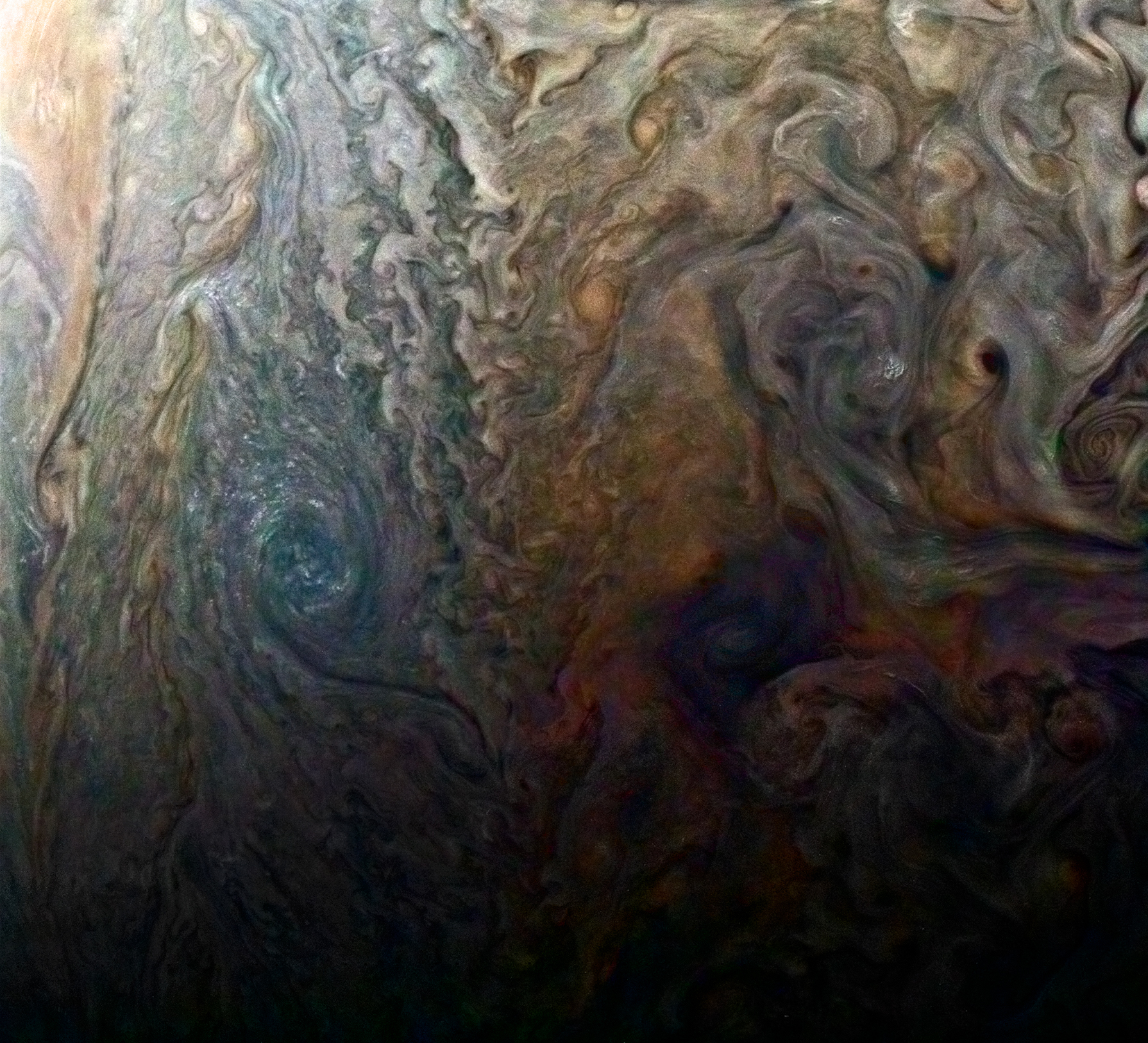 Diapositiva 3 de 11: This enhanced-color image of a mysterious dark spot on Jupiter seems to reveal a Jovian “galaxy” of swirling storms.