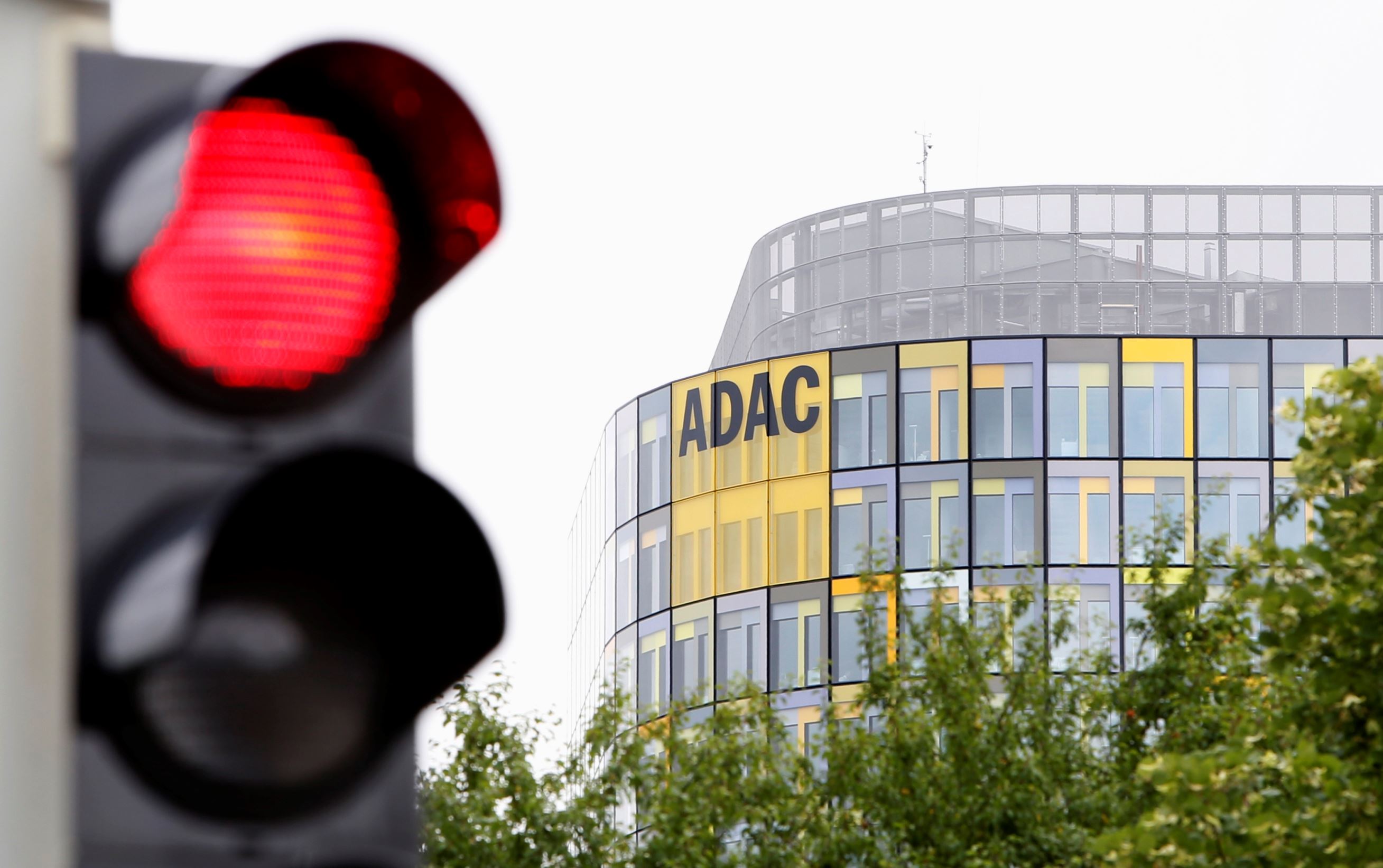 The ADAC headquarters triangular office tower is pictured next to a red traffic light before the annual news conference in Munich June 30, 2014. REUTERS/Michaela Rehle (GERMANY - Tags: BUSINESS CITYSCAPE POLITICS TRANSPORT)